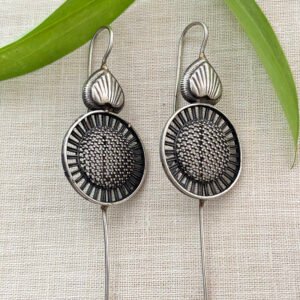 Earcuff with a textured circular motif and sleek spike accent